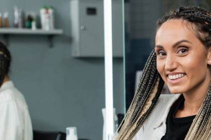 female client in hair salon,cheerful woman with braids