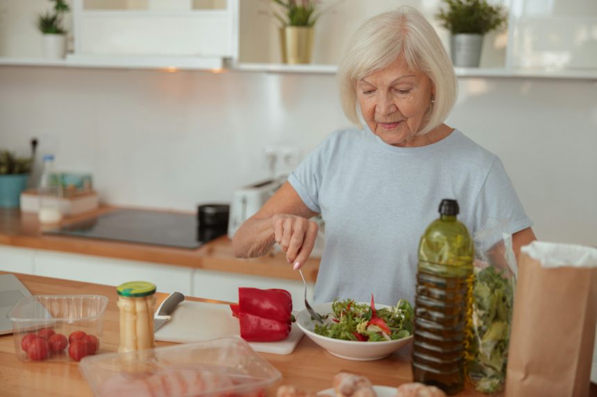 Good looking elderly female leading healthy lifestyle at home